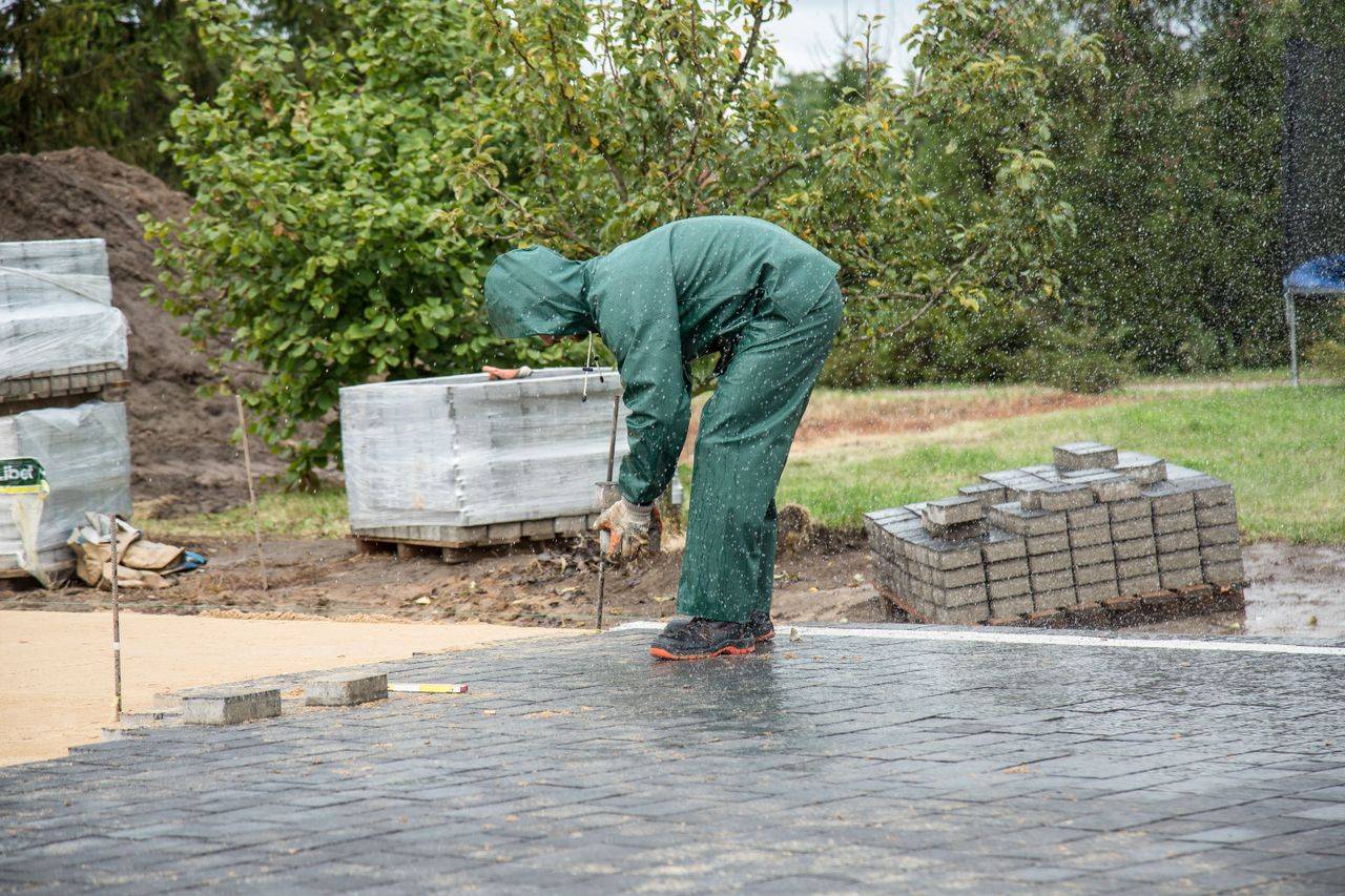 Landscaper installing paver stones